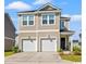 Two-story exterior elevation showcasing the double garage, neutral siding, covered entry, and well-manicured lawn at 3968 Hibiscus Dr., Little River, SC 29566