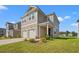 Exterior of a two-story home with attached garage, covered front porch, and well-manicured lawn at 3968 Hibiscus Dr., Little River, SC 29566