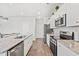 Spacious kitchen featuring stainless steel appliances, granite counters, and ample cabinet space at 3968 Hibiscus Dr., Little River, SC 29566