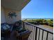 Relaxing balcony with seating area and partial view of the ocean at 417 South Dunes Dr. # B16, Pawleys Island, SC 29585