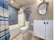 This bathroom showcases a decorative mirror, blue tile and ample towel storage at 417 South Dunes Dr. # B16, Pawleys Island, SC 29585