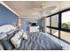 Bright bedroom with ceiling fan, large windows, and a partial ocean view at 417 South Dunes Dr. # B16, Pawleys Island, SC 29585