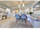 Stylish dining area featuring unique seating, modern lighting, and a seamless flow into the kitchen at 417 South Dunes Dr. # B16, Pawleys Island, SC 29585
