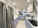 Modern kitchen with two-toned cabinets, stainless steel appliances and a view of the living area at 417 South Dunes Dr. # B16, Pawleys Island, SC 29585