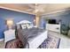 This main bedroom features blue walls, a ceiling fan and beachy decor at 417 South Dunes Dr. # B16, Pawleys Island, SC 29585