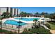 Enjoy the community pool in the complex with palm trees and covered lounge at 417 South Dunes Dr. # B16, Pawleys Island, SC 29585