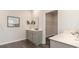 Bathroom featuring double vanity with modern fixtures, a framed mirror and a view into the walk-in closet at 418 Glade Ct., Loris, SC 29569