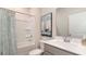 Bright bathroom featuring shower/tub combo, grey vanity, framed art and modern fixtures at 418 Glade Ct., Loris, SC 29569