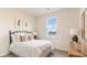 Cozy bedroom boasts a comfortable bed with decorative pillows, bright window and wooden bedside table at 418 Glade Ct., Loris, SC 29569