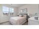 Bright bedroom features a large window, gray headboard, light colored walls and matching bedside lamps at 418 Glade Ct., Loris, SC 29569