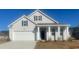 Charming single-Gathering home featuring a 2-car garage, a covered front porch, and classic architectural details at 418 Glade Ct., Loris, SC 29569