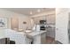Bright kitchen showcasing an island with seating, grey cabinets, and stainless steel appliances for modern living at 418 Glade Ct., Loris, SC 29569