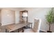 Well-lit office area featuring a decorative wood desk and accent shelving with stylish chair and plant at 418 Glade Ct., Loris, SC 29569