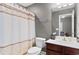 Well-lit bathroom with a shower-tub combination, a decorative shower curtain, and modern fixtures at 4311 Grovecrest Circle, North Myrtle Beach, SC 29582