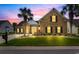 Charming brick home with a well-manicured lawn and palm trees, set against a vibrant sunset sky at 4311 Grovecrest Circle, North Myrtle Beach, SC 29582