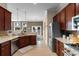 Functional kitchen featuring granite countertops, stainless steel appliances and rich wood cabinetry at 4311 Grovecrest Circle, North Myrtle Beach, SC 29582