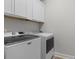 Bright laundry room with white cabinets, washer and dryer at 4311 Grovecrest Circle, North Myrtle Beach, SC 29582