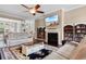 Inviting living room with a cozy fireplace, built-in bookshelves, and a ceiling fan at 4311 Grovecrest Circle, North Myrtle Beach, SC 29582