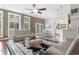Bright living area featuring large windows, hardwood floors, and an open floor plan at 4311 Grovecrest Circle, North Myrtle Beach, SC 29582