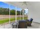 Cozy screened porch featuring comfortable seating and a view of the backyard at 4311 Grovecrest Circle, North Myrtle Beach, SC 29582