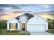 Charming one story home featuring a two-car garage, manicured lawn and craftsman style door with window at 435 Clear Lake Dr., Conway, SC 29526