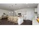 Open concept kitchen featuring hardwood floors, white cabinets and stainless steel appliances at 435 Clear Lake Dr., Conway, SC 29526