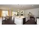 Open-concept living space with a large kitchen island, dining area, and comfortable living room with fireplace at 435 Clear Lake Dr., Conway, SC 29526