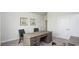 Spacious office features a desk with drawers and neutral-colored walls and carpeting at 435 Clear Lake Dr., Conway, SC 29526