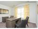 Office with a rustic wood desk, three chairs, yellow patterned curtains and neutral walls at 435 Clear Lake Dr., Conway, SC 29526