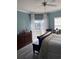 Bedroom showing a window and sliding glass door with a river view, a large bed, and a dresser at 4425 Eastport Blvd. # I-1, Little River, SC 29566