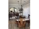Elegant dining room featuring wood table, decorative mirror, and stylish chandelier at 4425 Eastport Blvd. # I-1, Little River, SC 29566
