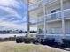 Condo back view of covered balconies overlooking a serene waterfront at 4425 Eastport Blvd. # I-1, Little River, SC 29566