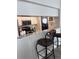Kitchen pass-through with granite counter, bar stools and view into kitchen appliances at 4425 Eastport Blvd. # I-1, Little River, SC 29566