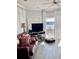 Bright living room with water views, leather sofa, and light flooring at 4425 Eastport Blvd. # I-1, Little River, SC 29566