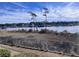 Scenic waterfront view with marshy shoreline and waterfront homes in the background at 4425 Eastport Blvd. # I-1, Little River, SC 29566