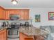 Close up of kitchen with appliances and granite countertops next to the living room at 4516 Seaview St. # 135, North Myrtle Beach, SC 29582