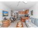 Inviting living room with a couch, dinette, TV, and open kitchen with island and barstool seating at 4516 Seaview St. # 135, North Myrtle Beach, SC 29582