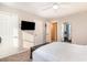Bedroom with closet doors, overhead fan, television, and adjoining bathroom at 4616 Lomax Ct. # 9-B, Murrells Inlet, SC 29576