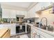 Well-lit kitchen with white cabinetry, stainless steel appliances, and ample counter space at 4616 Lomax Ct. # 9-B, Murrells Inlet, SC 29576