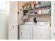 Laundry room with a washer, dryer, and storage shelves for convenience at 4616 Lomax Ct. # 9-B, Murrells Inlet, SC 29576