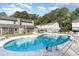 Inviting community pool surrounded by lounge chairs and mature trees at 4616 Lomax Ct. # 9-B, Murrells Inlet, SC 29576