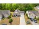 Aerial view of a charming home with a well-manicured lawn, driveway, and lush surrounding trees at 4697 Farm Lake Dr., Myrtle Beach, SC 29579