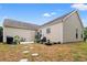 Spacious backyard with a patio, stepping stones, and lush landscaping, perfect for outdoor enjoyment at 4697 Farm Lake Dr., Myrtle Beach, SC 29579