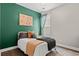 Inviting bedroom with a vibrant green accent wall and cozy bedding for a relaxing retreat at 4697 Farm Lake Dr., Myrtle Beach, SC 29579
