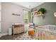 Charming Bedroom with a changing table, comfortable chair, crib, and decorative shelving at 4697 Farm Lake Dr., Myrtle Beach, SC 29579