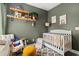 Stylized Bedroom featuring a white crib, a cozy rocking chair, and decorative wall art at 4697 Farm Lake Dr., Myrtle Beach, SC 29579