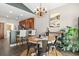 Charming dining area featuring a round wooden table, chandelier lighting, and an adjacent kitchen with bar seating at 4697 Farm Lake Dr., Myrtle Beach, SC 29579