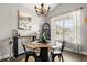 Dining room featuring a round table, modern chandelier, and bright window with sheer curtains at 4697 Farm Lake Dr., Myrtle Beach, SC 29579
