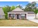 Charming brick home with a welcoming front porch and well-maintained lawn, featuring two wooden chairs at 4697 Farm Lake Dr., Myrtle Beach, SC 29579