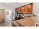 Well-equipped kitchen with wooden cabinets, granite countertops, stainless steel appliances, and modern backsplash at 4697 Farm Lake Dr., Myrtle Beach, SC 29579
